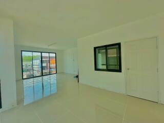 Spacious and bright unfurnished bedroom with glossy tiled flooring and ample natural light