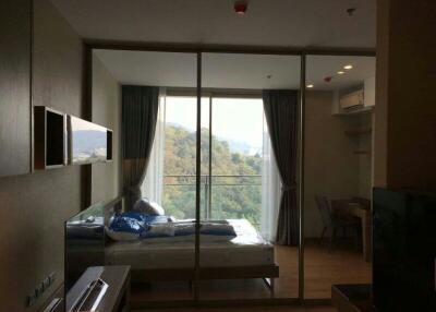 Modern bedroom with glass wall and scenic view