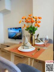 Cozy dining area with modern table set and television in background