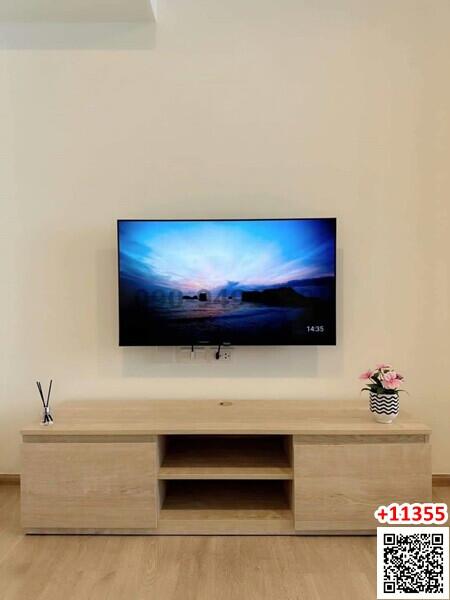 Modern living room with wall-mounted TV and minimalist TV stand