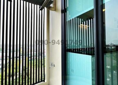 Spacious balcony with safety railing and large glass doors