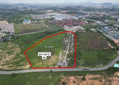 Aerial perspective of a large undeveloped plot of land outlined for property development