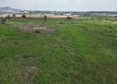 Expansive outdoor land available for development with a view of distant buildings