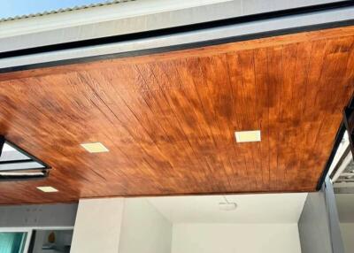 Modern home facade with wooden ceiling detail