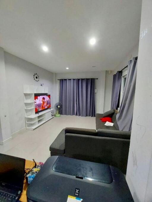 Spacious living room with modern furnishings and entertainment setup