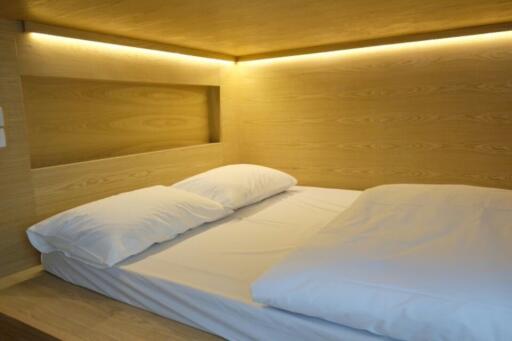 Modern bedroom with a large bed and ambient lighting
