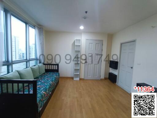 Spacious bedroom with modern furnishings and large windows providing ample natural light