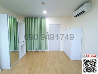 Spacious bedroom with modern flooring and air conditioning