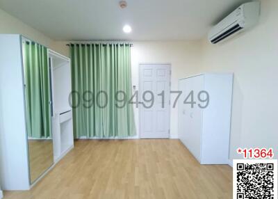 Spacious bedroom with modern flooring and air conditioning