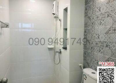 Modern bathroom with white tiles and decorative wall