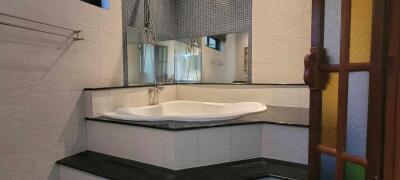 Spacious modern bathroom with Jacuzzi tub and ambient lighting