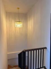 Elegant staircase with modern chandelier lighting