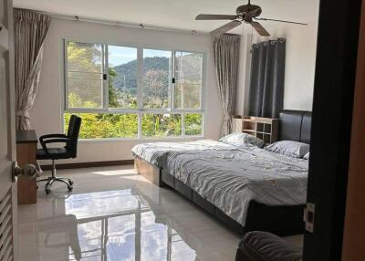 Spacious bedroom with natural lighting and scenic view