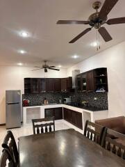 Modern kitchen interior with dark cabinets and stainless steel appliances