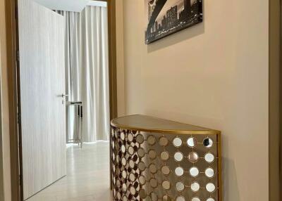 Elegant hallway interior with decorative round console and wall art
