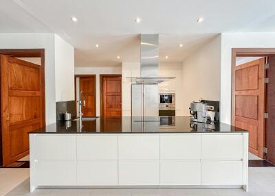 Modern kitchen with stainless steel appliances and wooden accents
