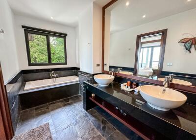Spacious bathroom with dual sinks and modern bathtub