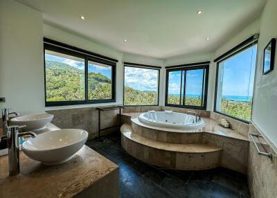 Spacious bathroom with natural light and a view
