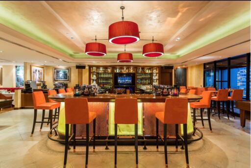 Elegant bar area with red pendant lighting and comfortable seating