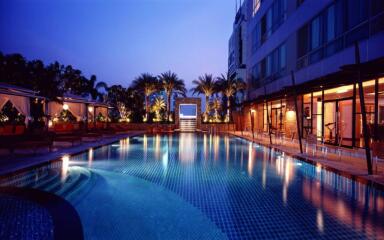 Elegant outdoor swimming pool area with ambient lighting
