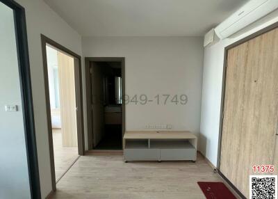 Spacious and bright unfurnished bedroom with wooden wardrobe and tiled flooring