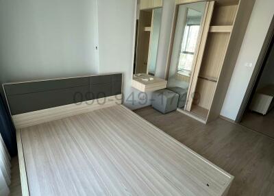 Spacious modern bedroom with laminate flooring and built-in wardrobe
