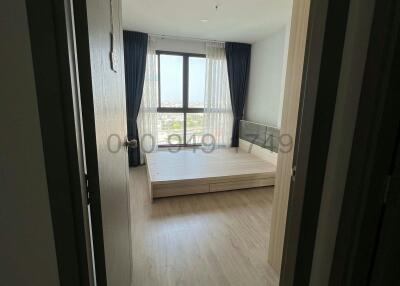 Spacious bedroom with ample natural light and a balcony view