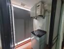 Compact laundry area with washing machine and wall-mounted air-conditioning unit