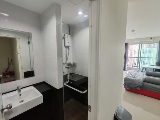 Modern bathroom with glass shower and view of adjoining bedroom
