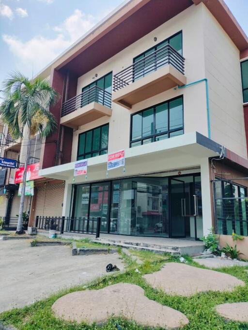 Modern three-story building with commercial space available for rent on the ground floor