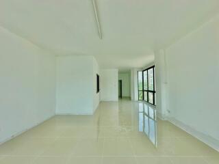 Spacious and bright empty interior of a building with glossy tile flooring