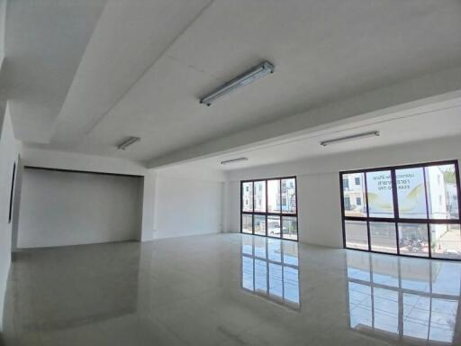 Spacious and bright empty commercial space with large windows