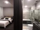 Modern bedroom with en-suite bathroom featuring glass walls