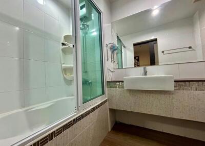 Modern bathroom with shower cabin and bathtub