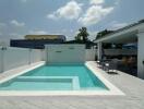 Modern residential swimming pool with adjacent shaded patio