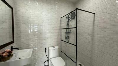 Modern bathroom with white subway tiles and glass shower