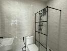 Modern bathroom with white subway tiles and glass shower