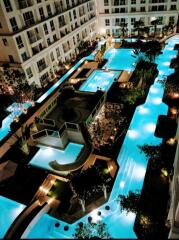 Luxurious residential complex with illuminated pool and water slide at night