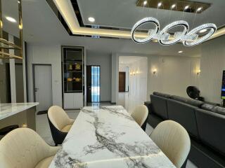 Modern dining room with elegant chandelier and marble table