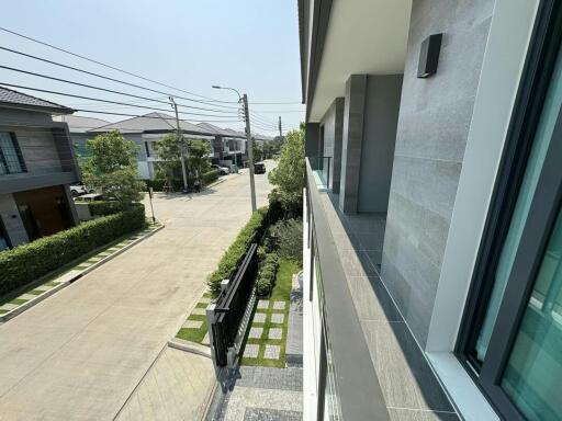 View from balcony of modern residential area with surrounding houses and greenery