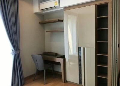Compact bedroom with built-in wardrobe and study desk