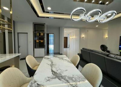 Modern dining room interior with elegant chandelier and marble table