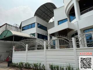 Modern two-story residential building with gated entrance