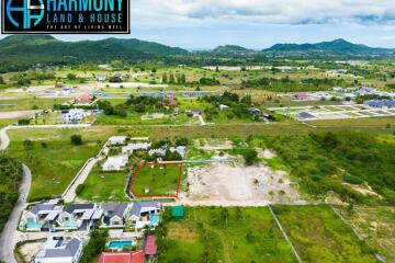 Aerial view of a residential area showcasing a plot of land for sale