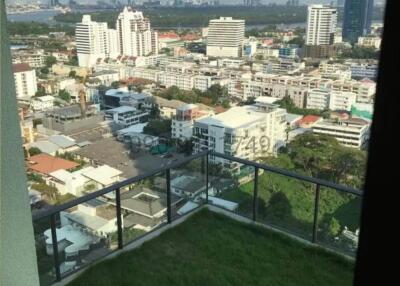 City view from high-rise apartment balcony with artificial grass
