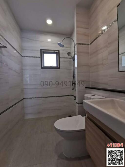 Modern bathroom with neutral tiled walls and flooring