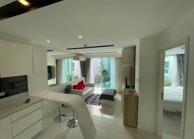 Spacious living room with modern open kitchen and balcony access