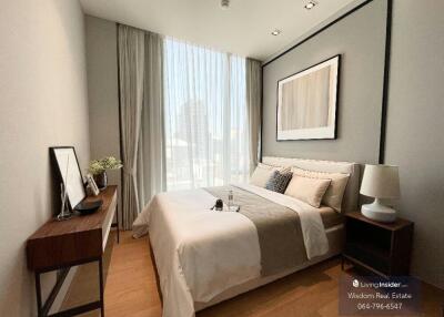 Bright and modern bedroom with large windows and comfortable furnishings