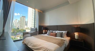 Modern bedroom with large windows overlooking the city