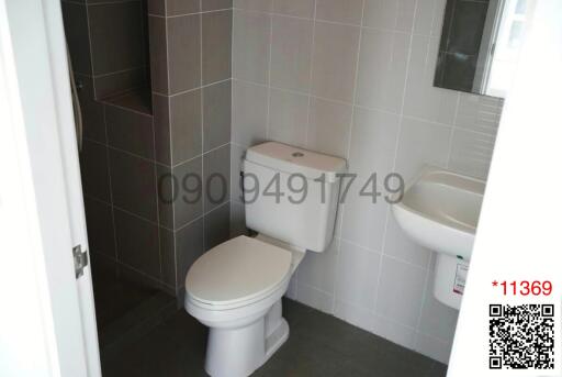 Modern tiled bathroom with toilet and sink